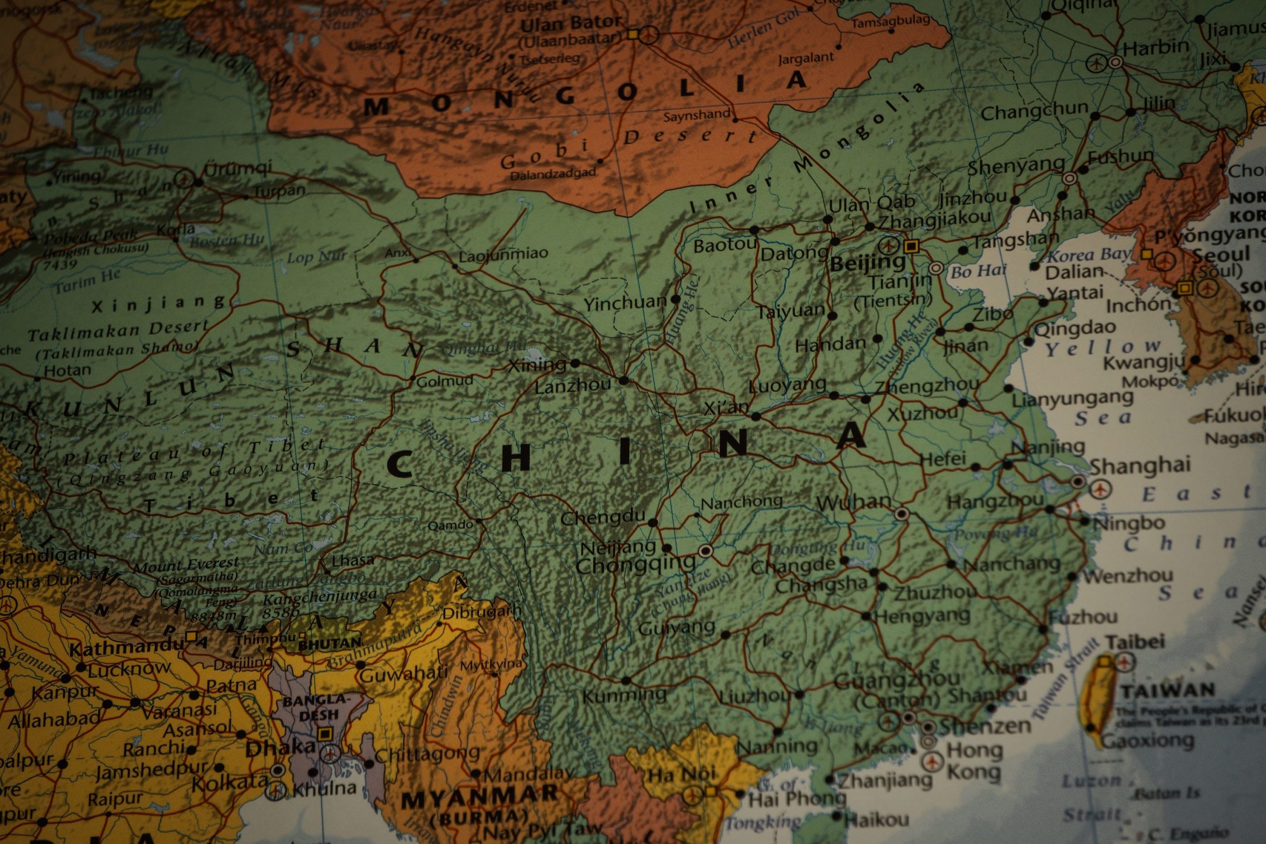 Map highlighting China, Hong Kong, and Belt and Road Initiative trading partners with digital currency icons representing yuan-backed stablecoins
